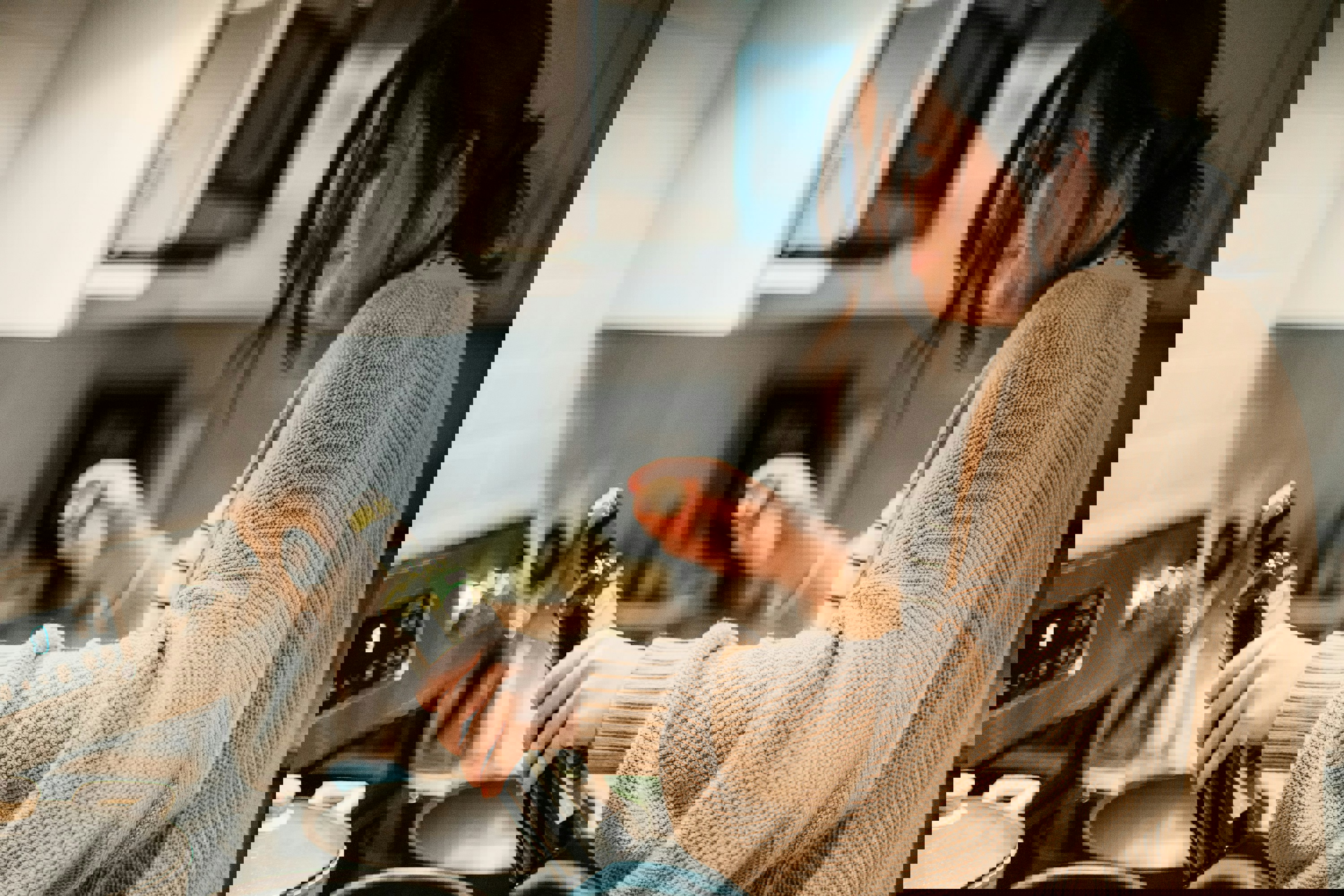 a woman is pouring olive oil into a frying pan