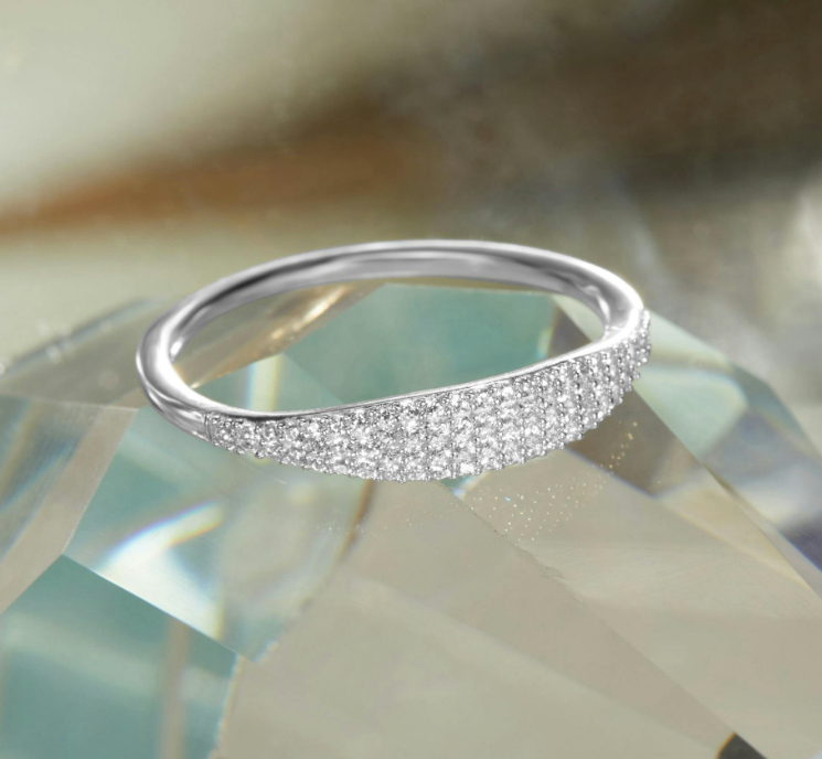 a silver ring is sitting on top of a crystal