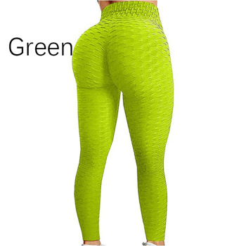 a woman is wearing a pair of green leggings .