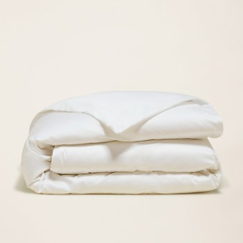a white comforter is stacked on top of each other