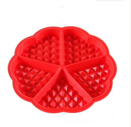 a red heart shaped waffle maker with triangles on it