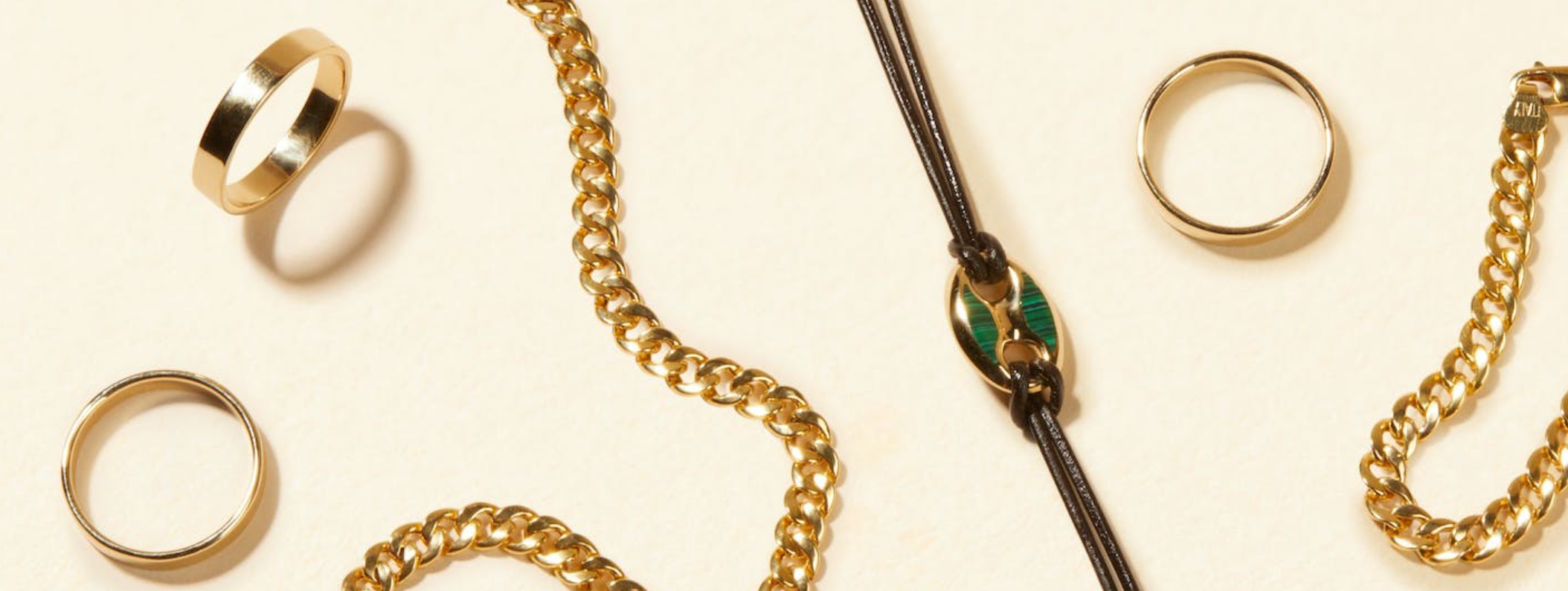 a collection of gold jewelry including a necklace and rings