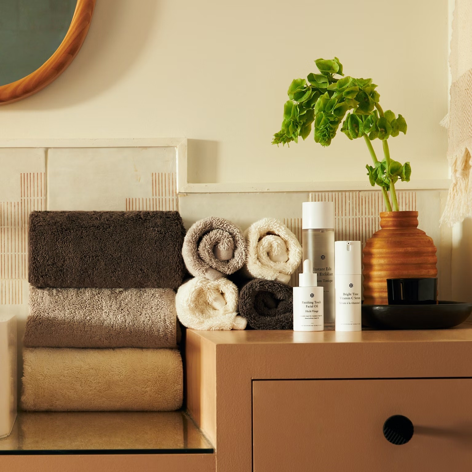 a bottle of lotion sits on a counter next to towels