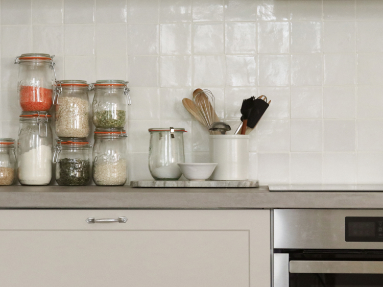 a kitchen counter with jars of spices and utensils