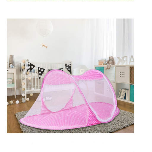 a pink mosquito net is in a nursery next to a crib