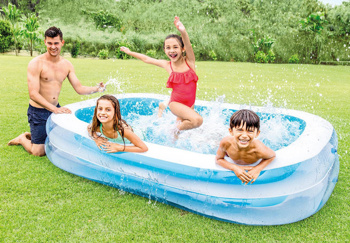 a family is playing in a large inflatable pool