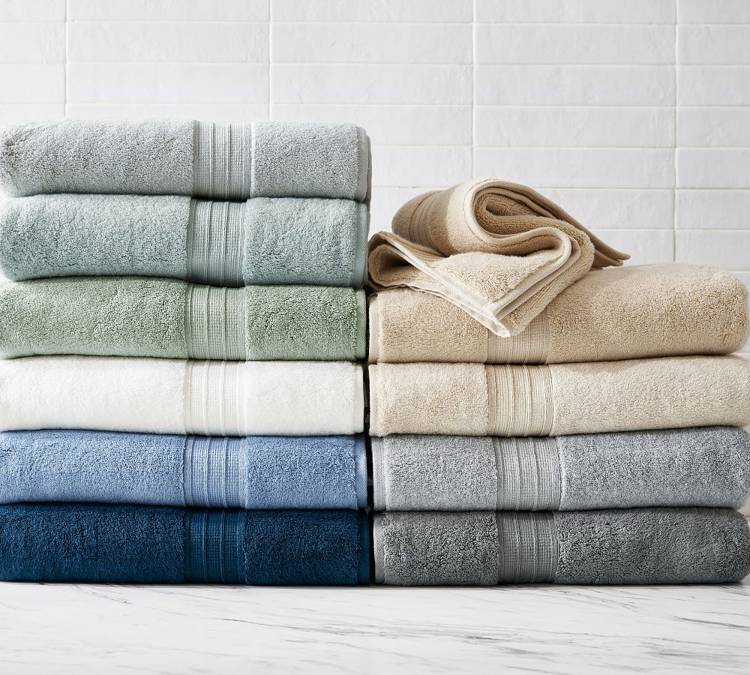 a bunch of towels are stacked on top of each other on a counter