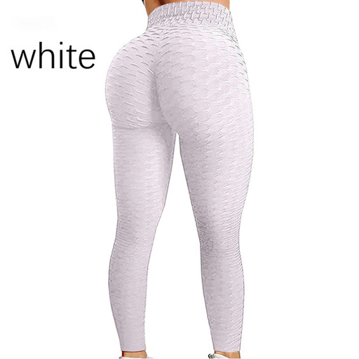 a woman is wearing a pair of white leggings .