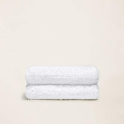 two white towels are stacked on top of each other