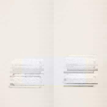 two white towels are stacked on top of each other