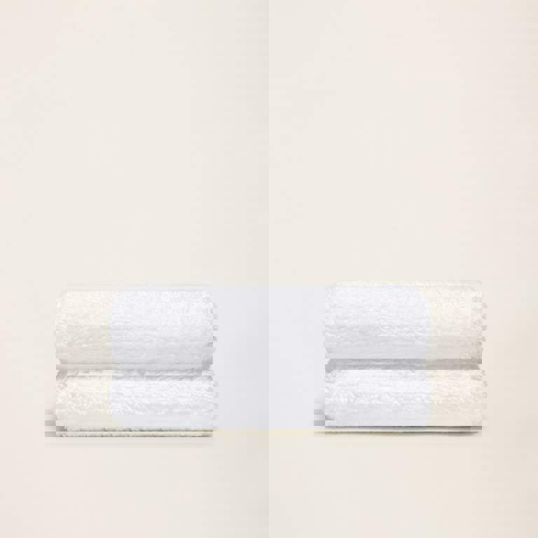 two white towels are stacked on top of each other