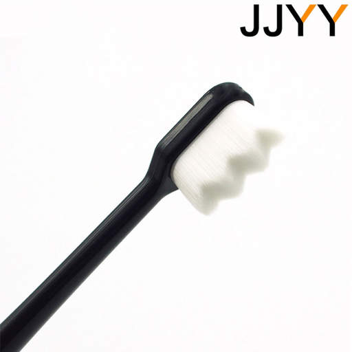 a toothbrush with a black handle and white bristles is labeled jjyy