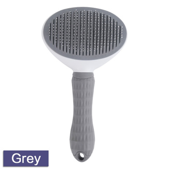 a grey dog brush with a white handle