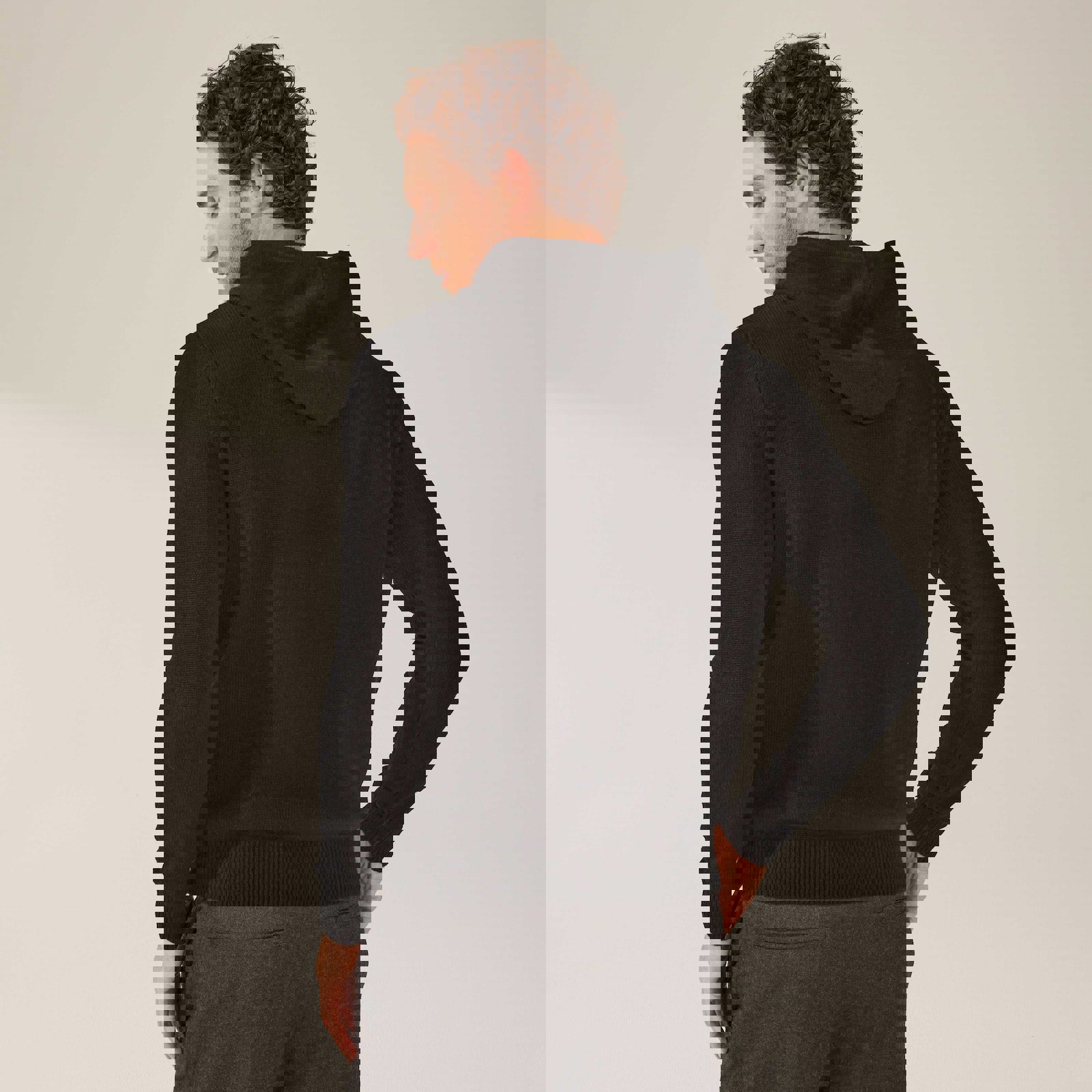 a man is wearing a black hoodie and grey sweatpants