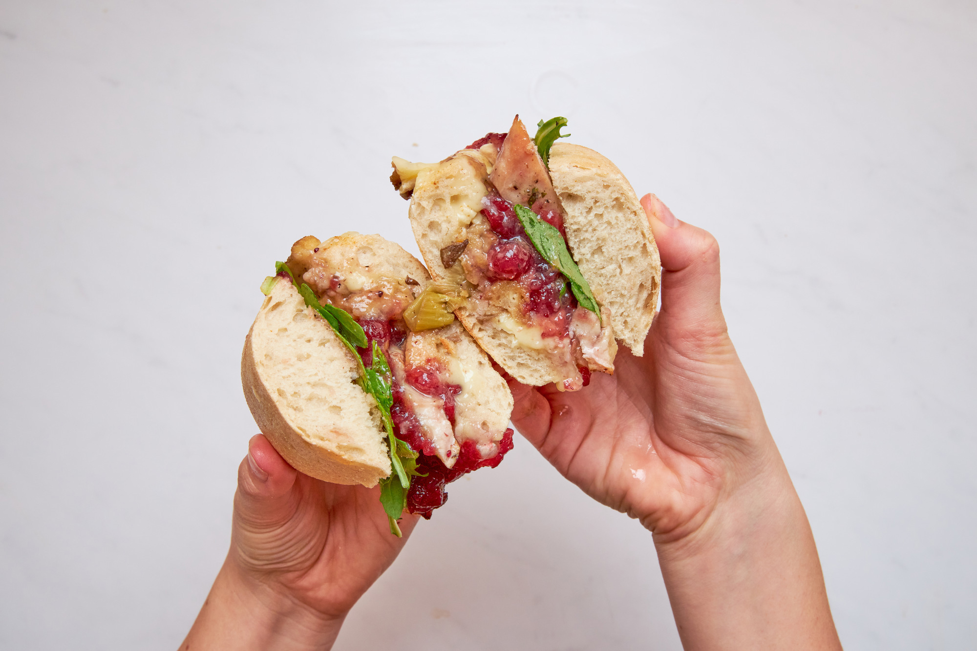 a person is holding a half eaten sandwich in their hands