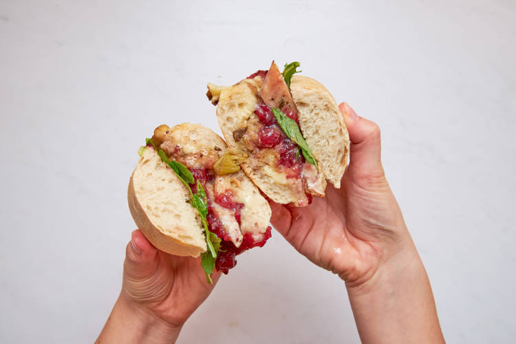 Jow Meal Planning a person is holding a half eaten sandwich in their hands
