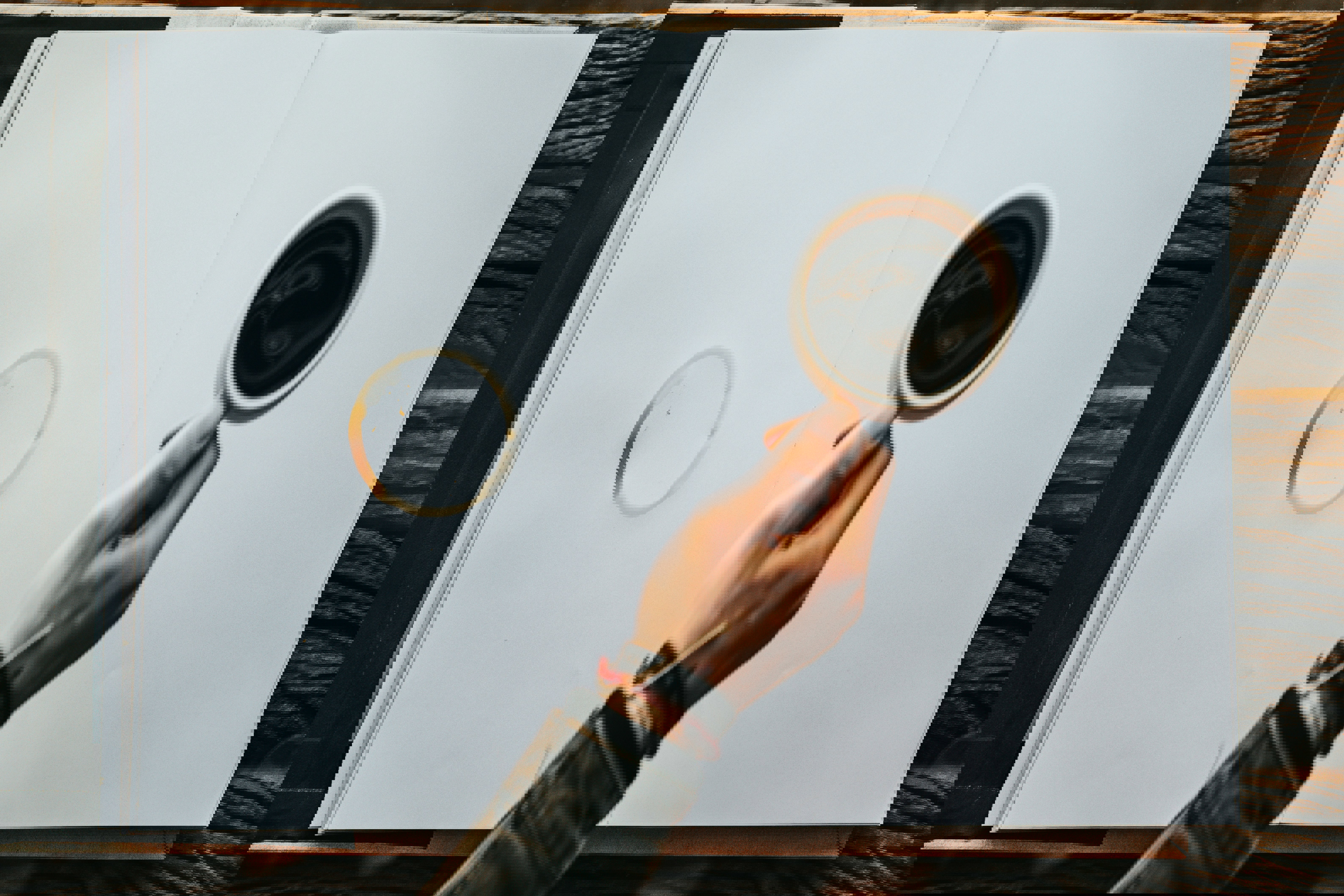 a person is holding a cup of coffee in front of an open book