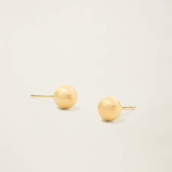 a pair of gold stud earrings on a white surface