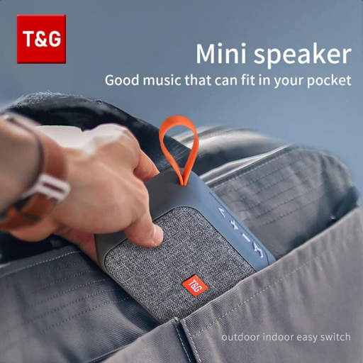 a person is holding a small speaker that says t & g on it