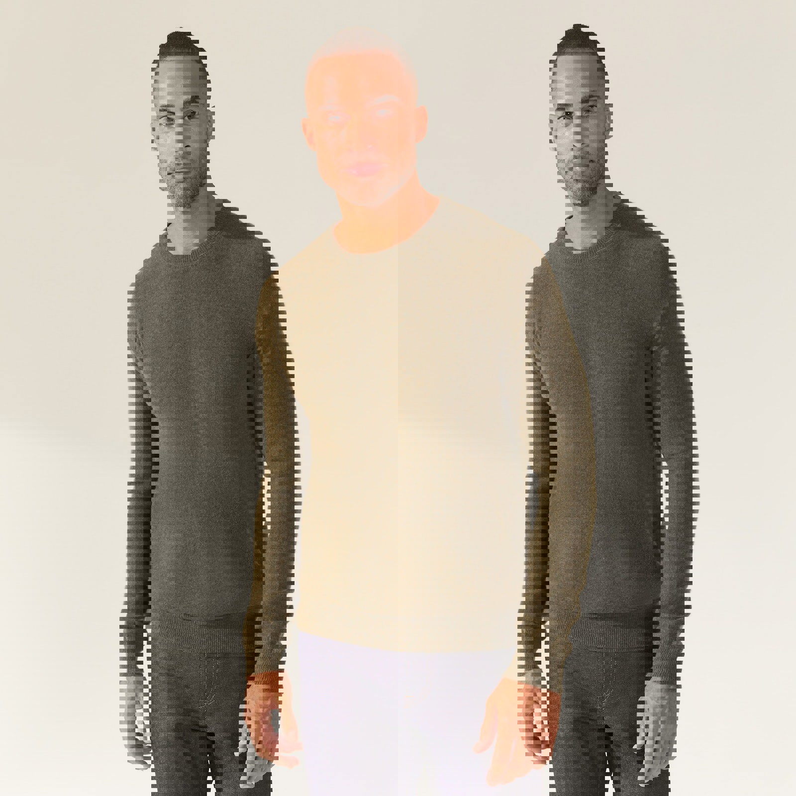 a man is wearing a green sweater and jeans