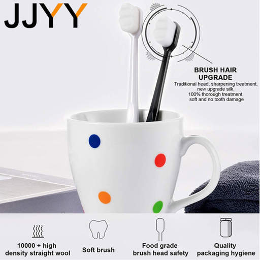 two toothbrushes are in a white mug with polka dots
