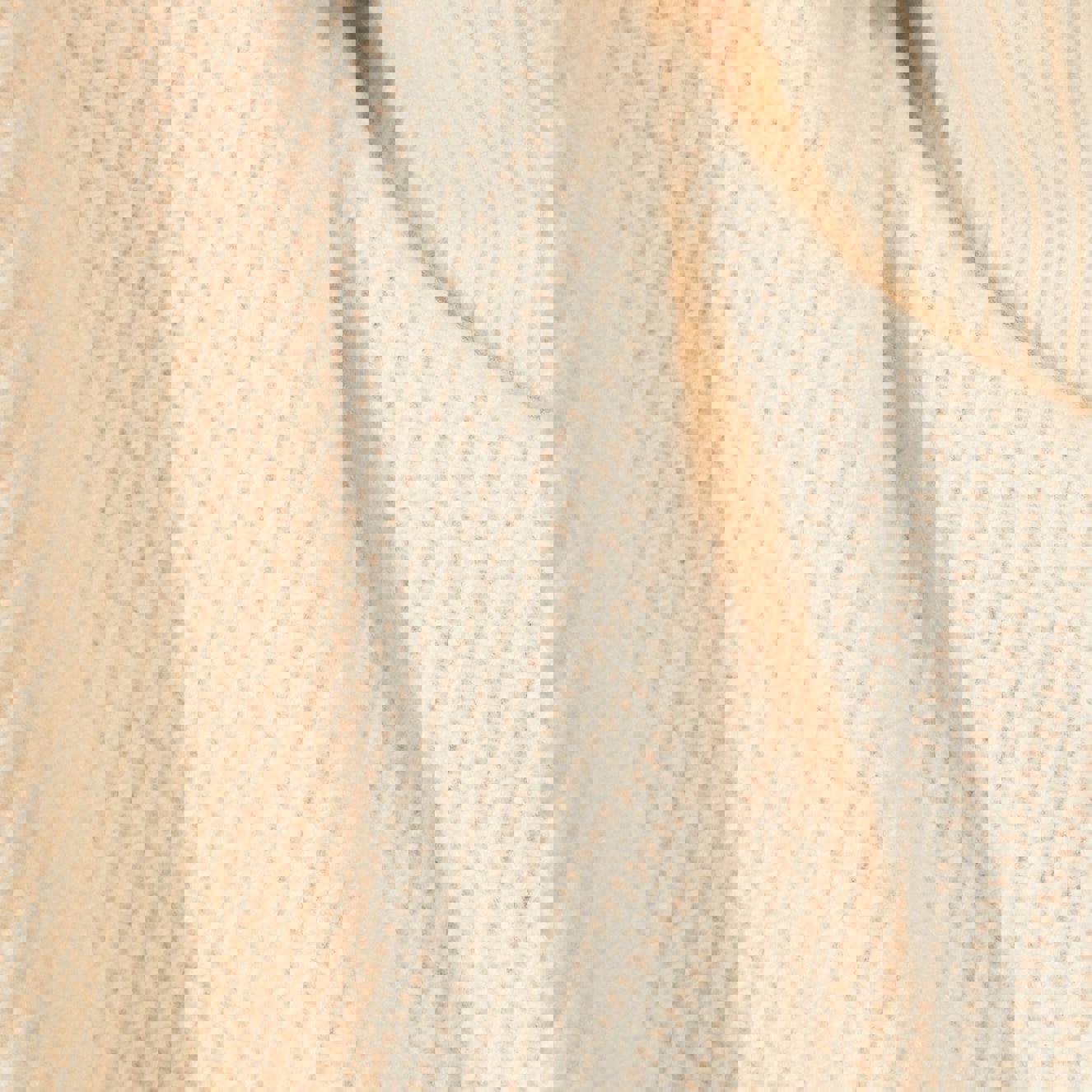 a close up of a white sweater with a turtleneck