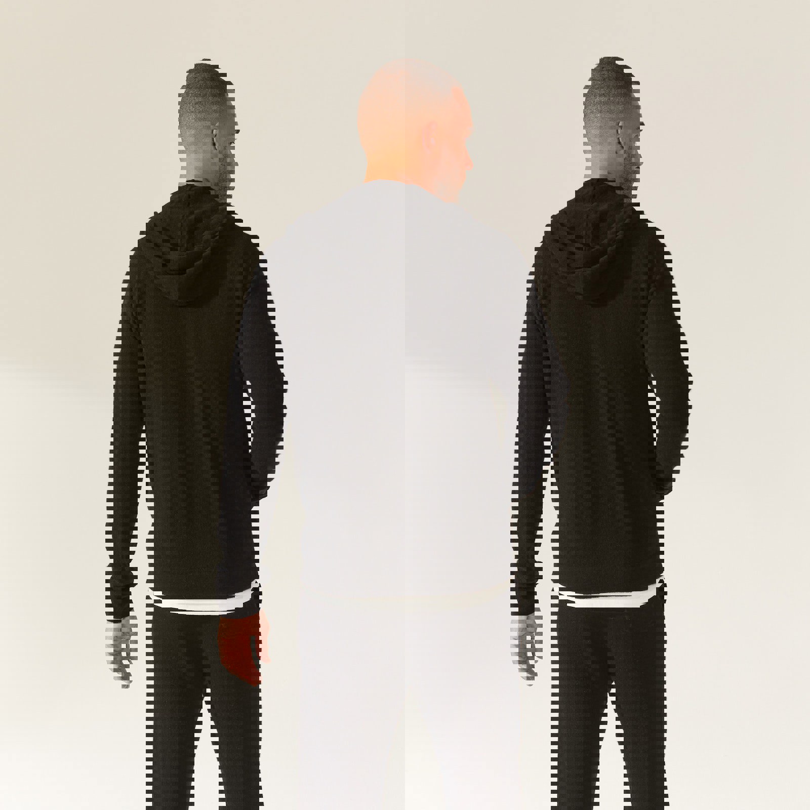 a man is wearing a black hoodie and black sweatpants