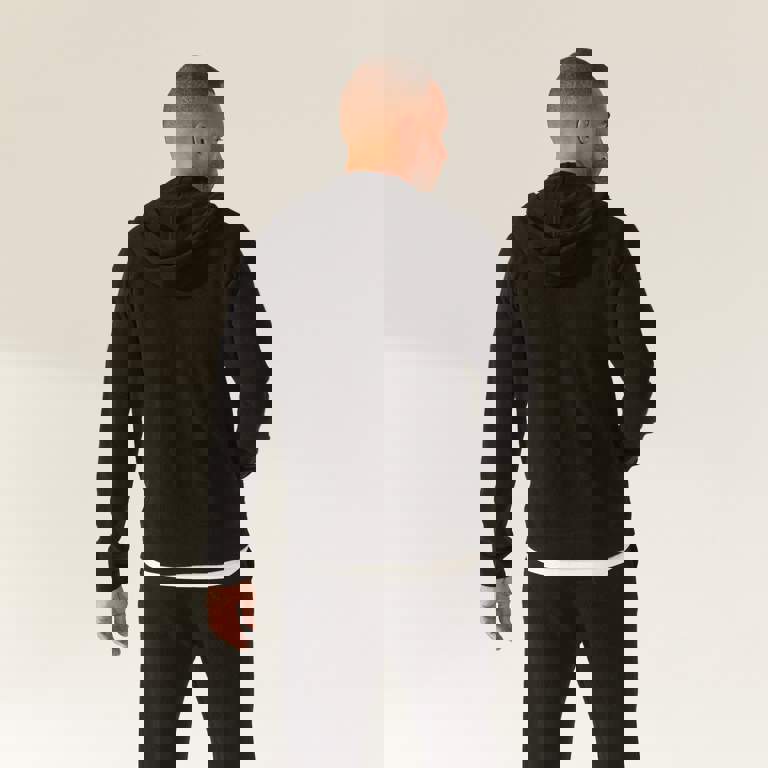 a man is wearing a black hoodie and black sweatpants