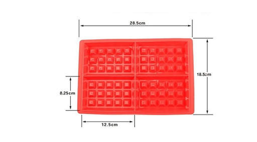 a red silicone waffle maker with measurements on a white background .