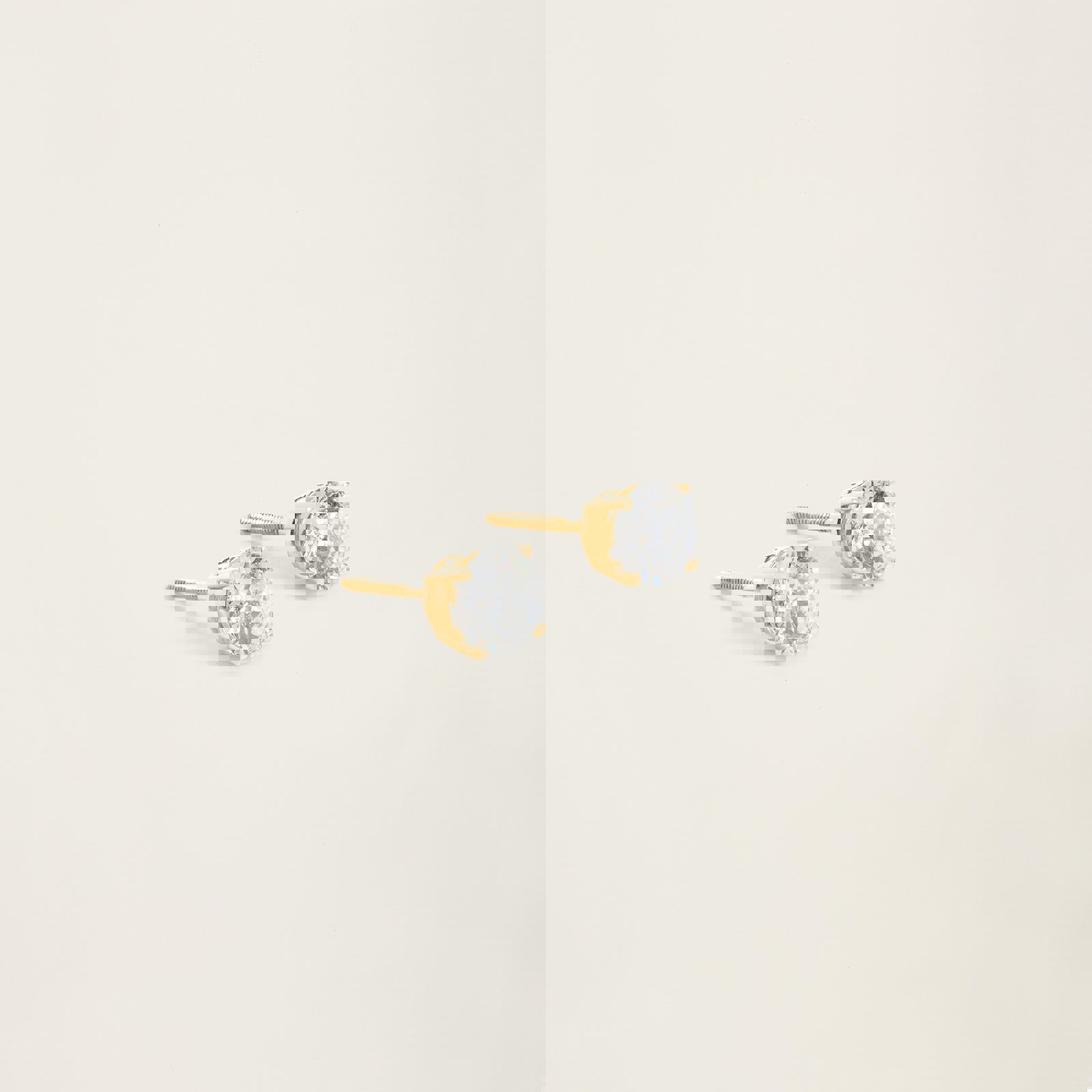 a pair of gold stud earrings with clear stones