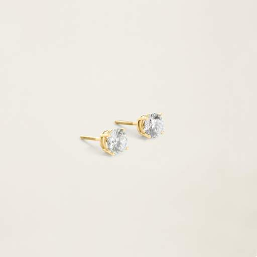 a pair of gold stud earrings with clear stones