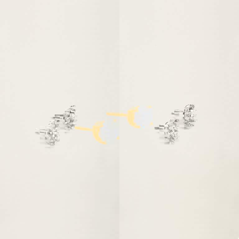 a pair of gold stud earrings with clear stones