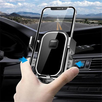 a person is holding a cell phone in a car holder