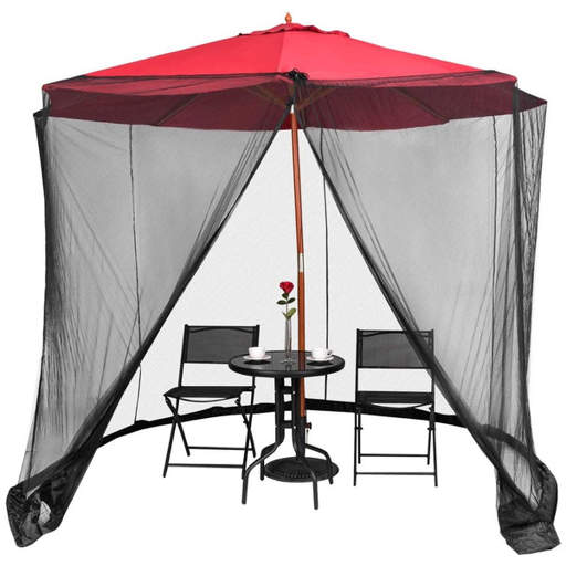 a table and chairs under an umbrella with a mosquito net