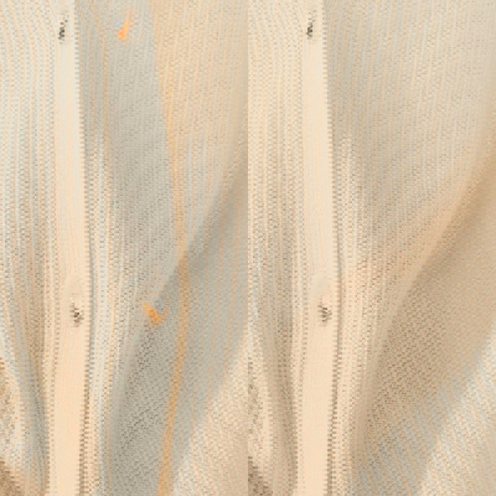 a close up of a white sweater with buttons