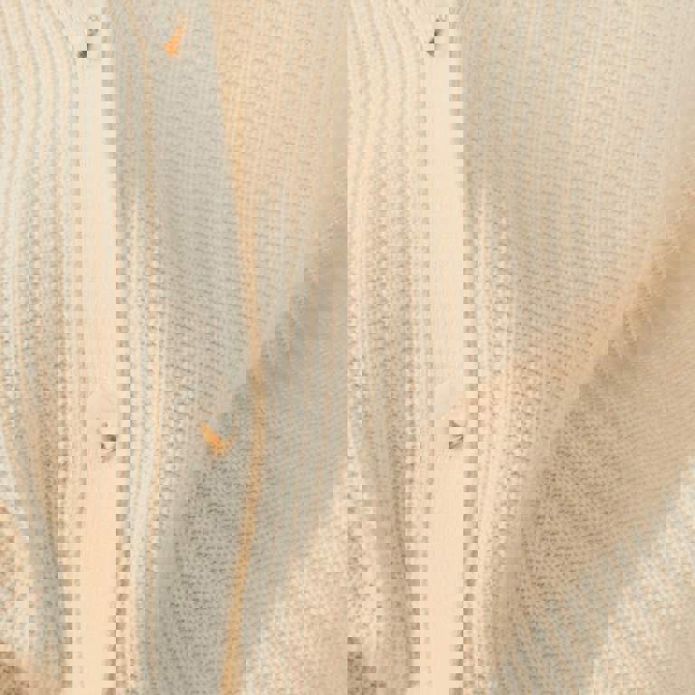a close up of a white sweater with buttons