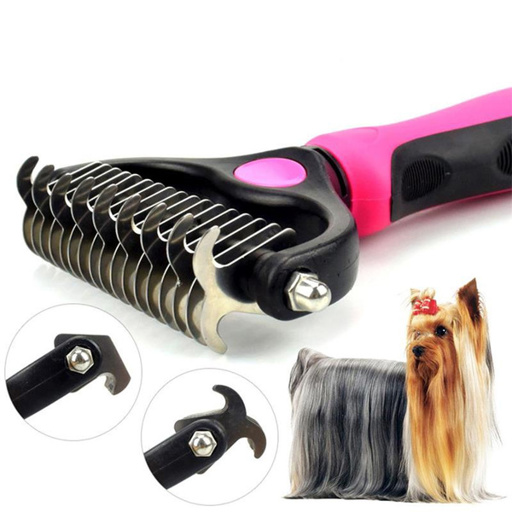 a yorkshire terrier is standing next to a brush with a pink handle