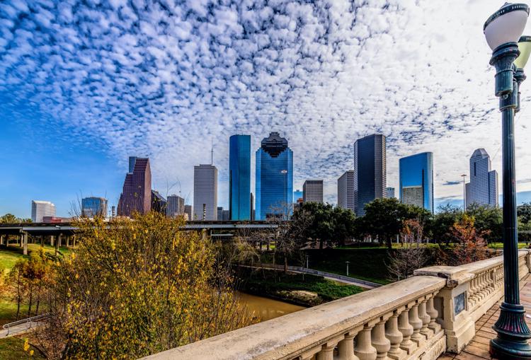 a view of the skyline of houston from a bridge