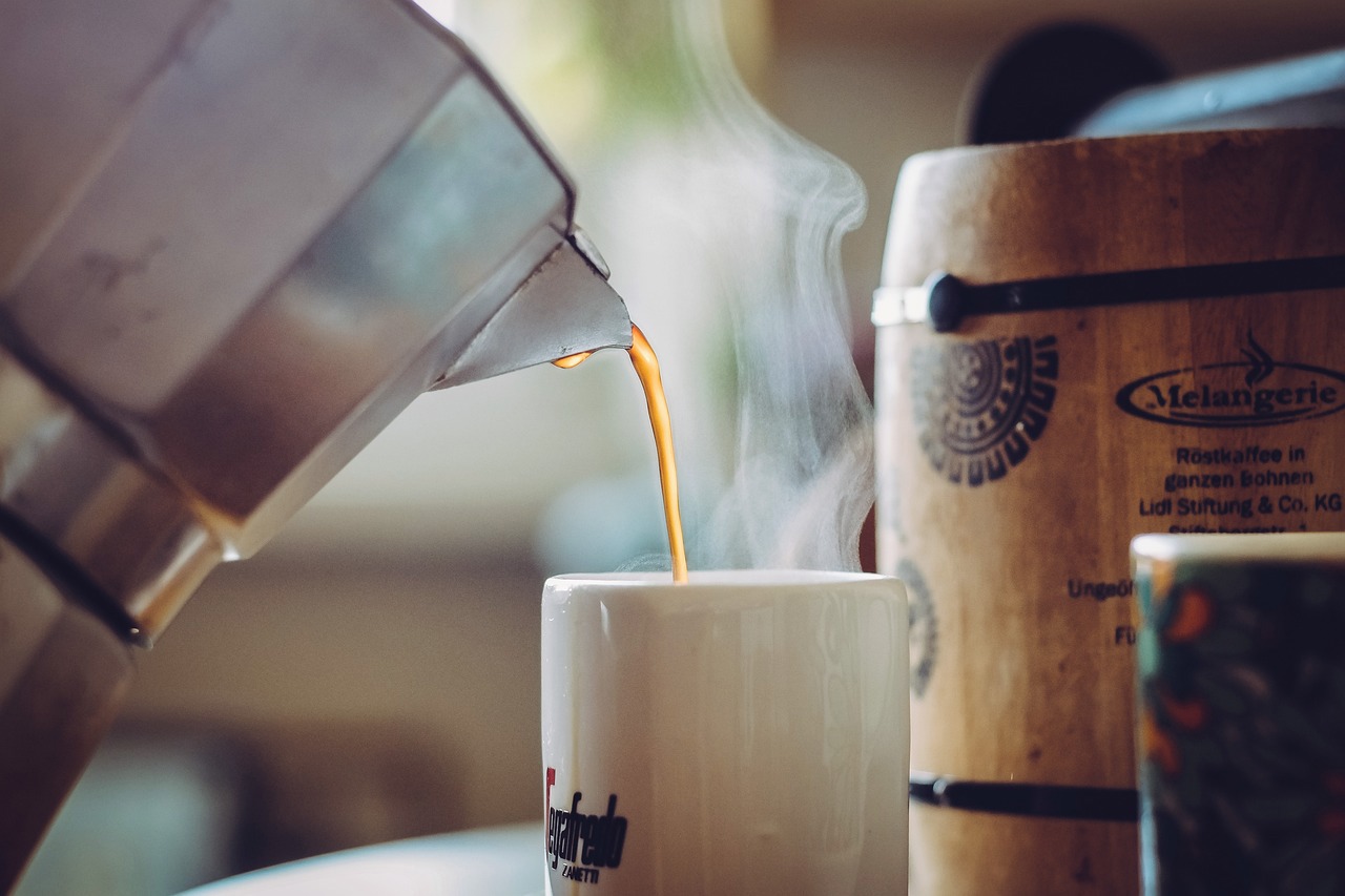 a cup of coffee is being poured into a melangerie barrel