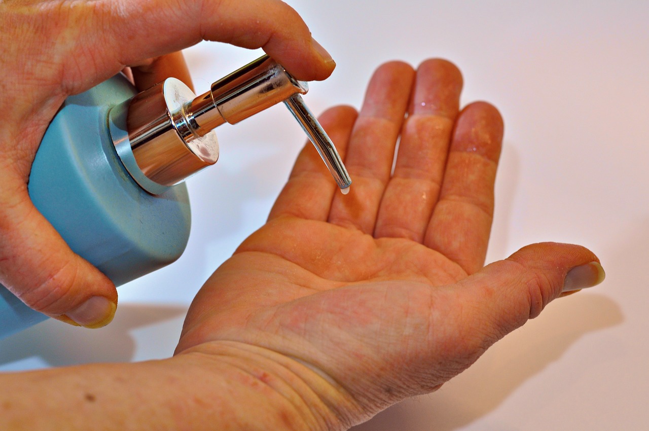 a person is applying soap to another person 's hand