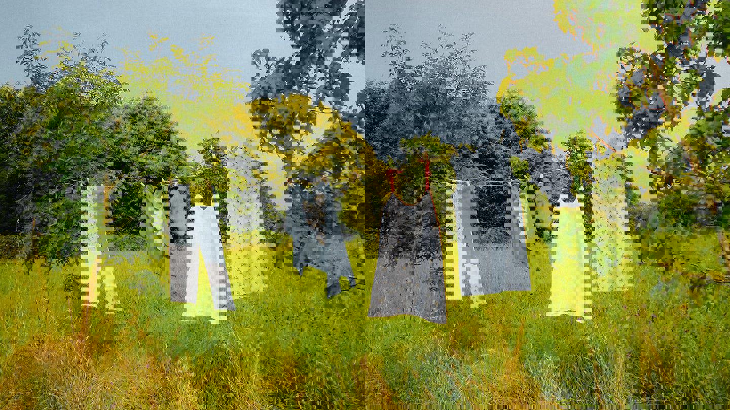 clothes hanging on a clothes line in a field