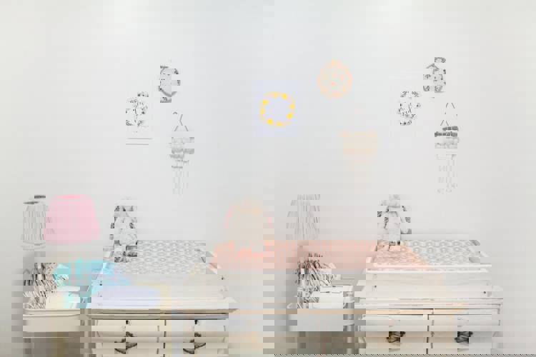 a room with a changing table and a lamp