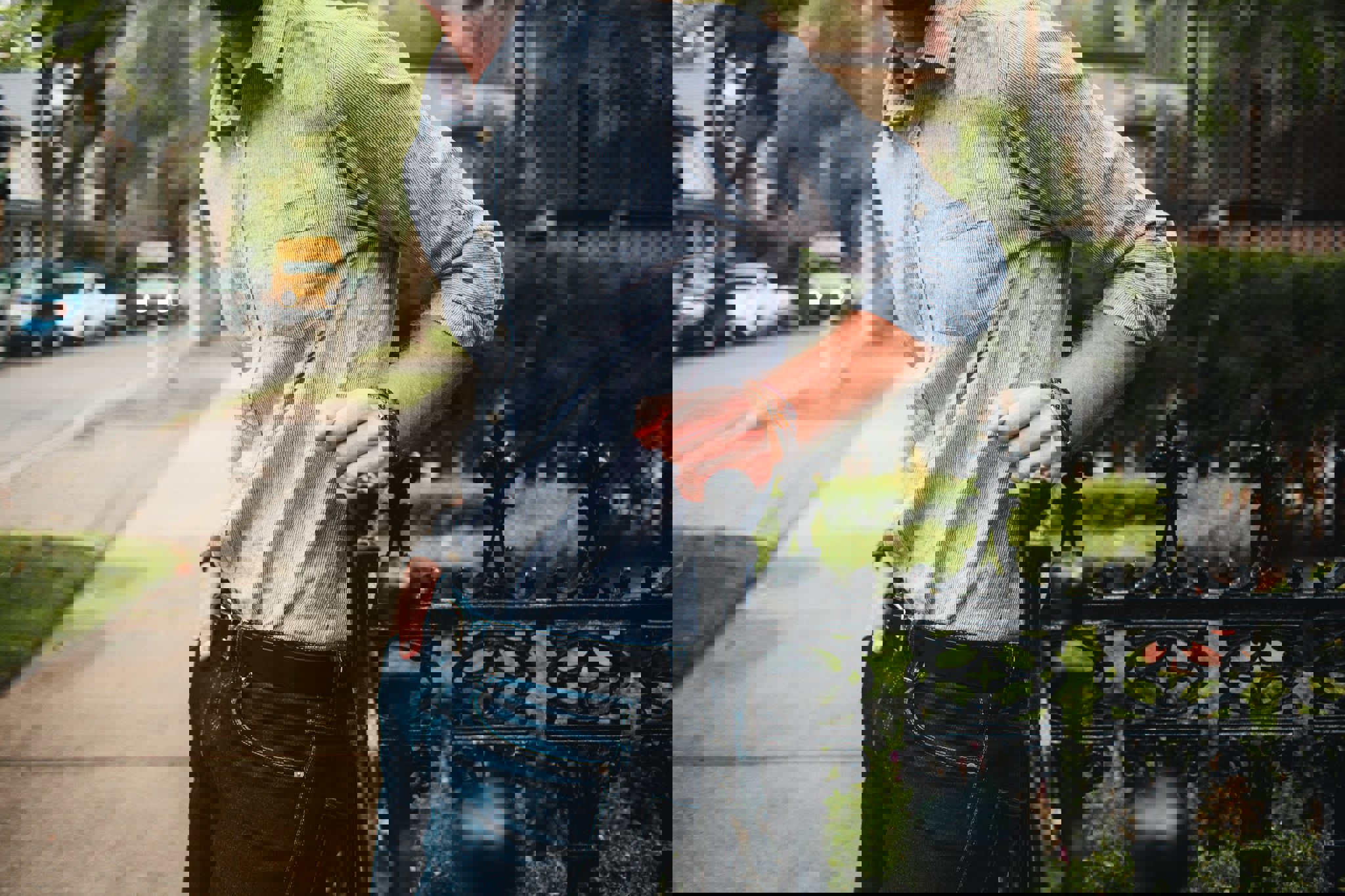 a man leaning on a fence with his hands in his pockets