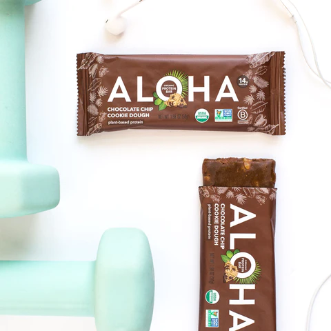 a chocolate chip cookie dough bar is sitting next to a dumbbell