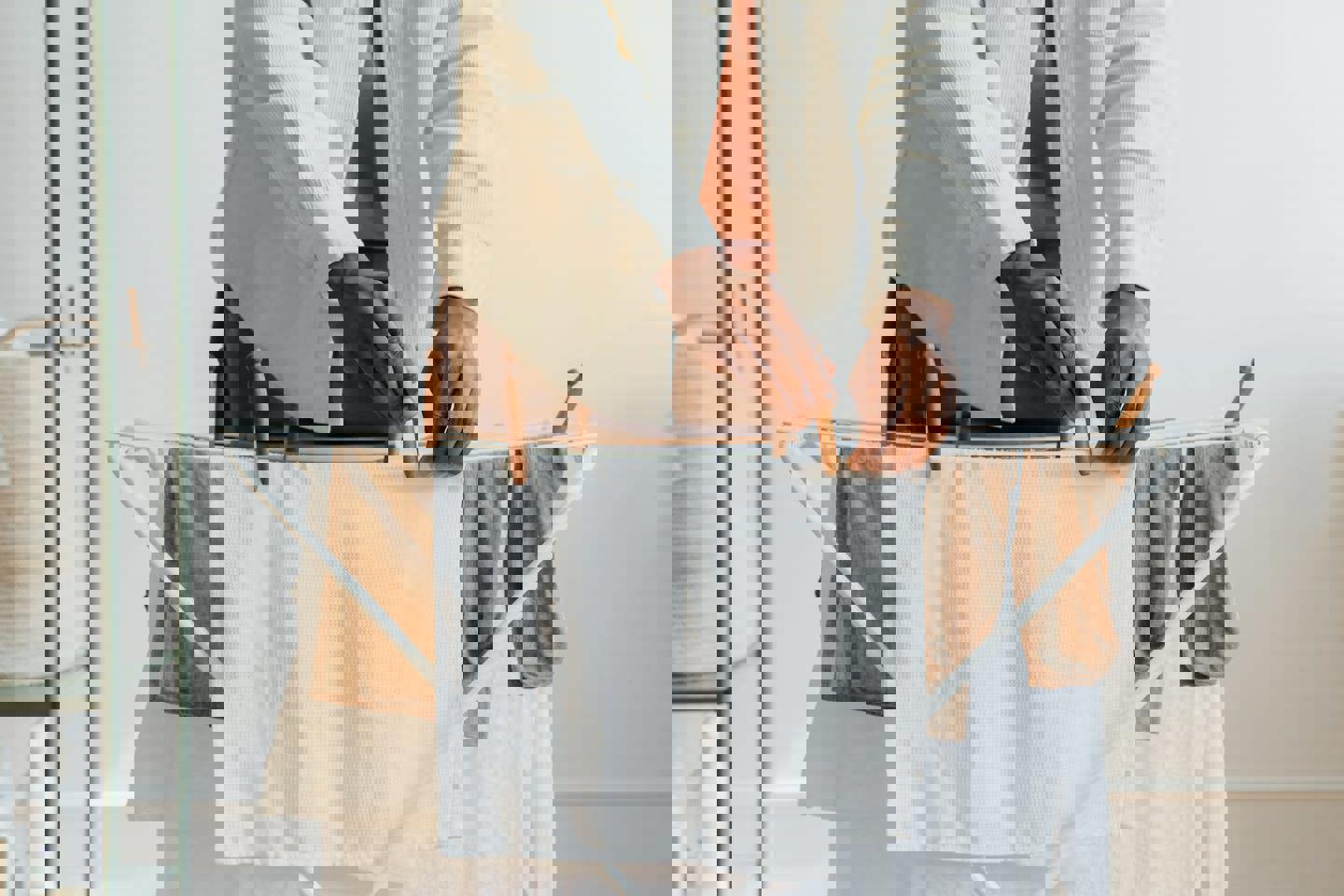 a person is hanging clothes on a drying rack