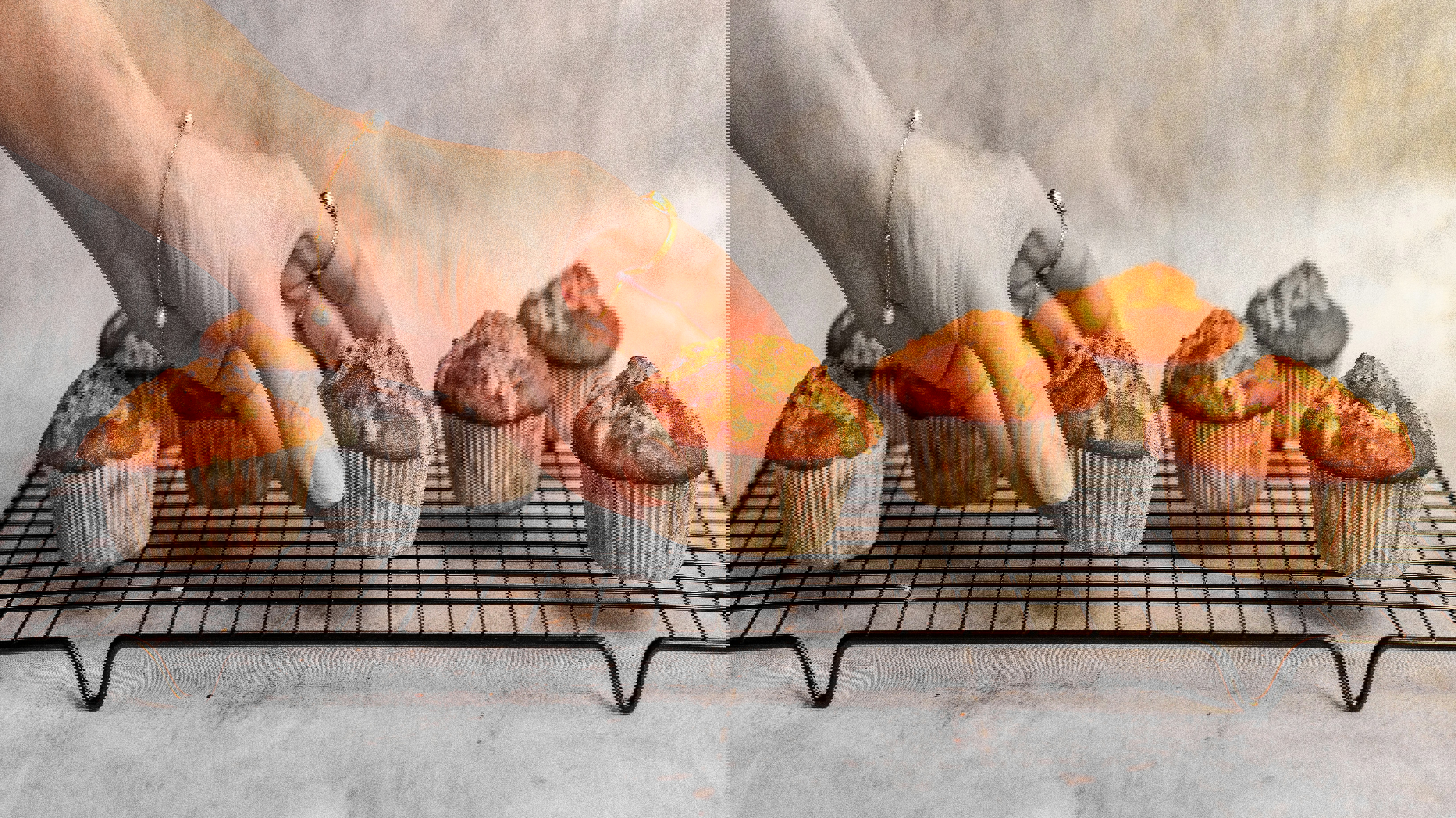 a woman reaches for a cupcake on a cooling rack
