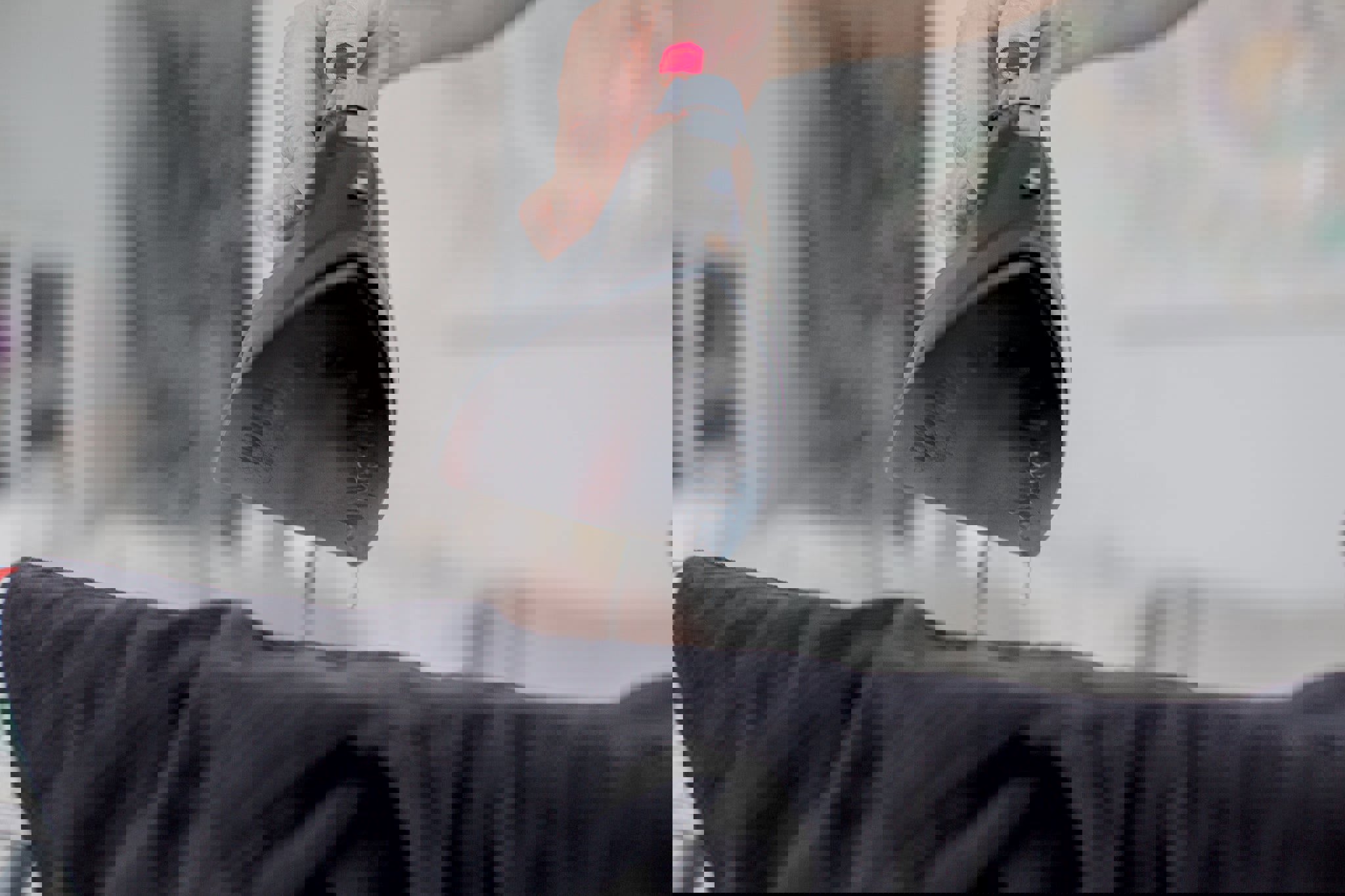 a person with red nails is ironing a black shirt