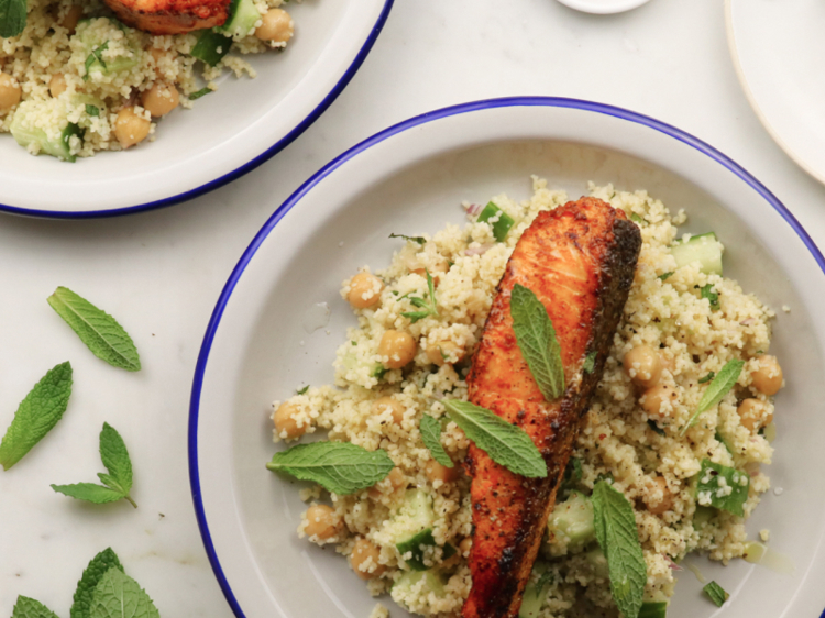 a plate of food with couscous and salmon on it