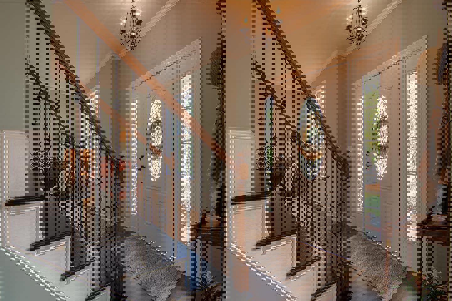 a staircase leading up to a white door with a wreath on it