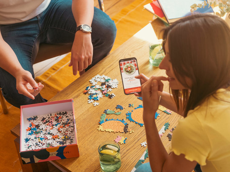 a man and a woman are playing a game of puzzles